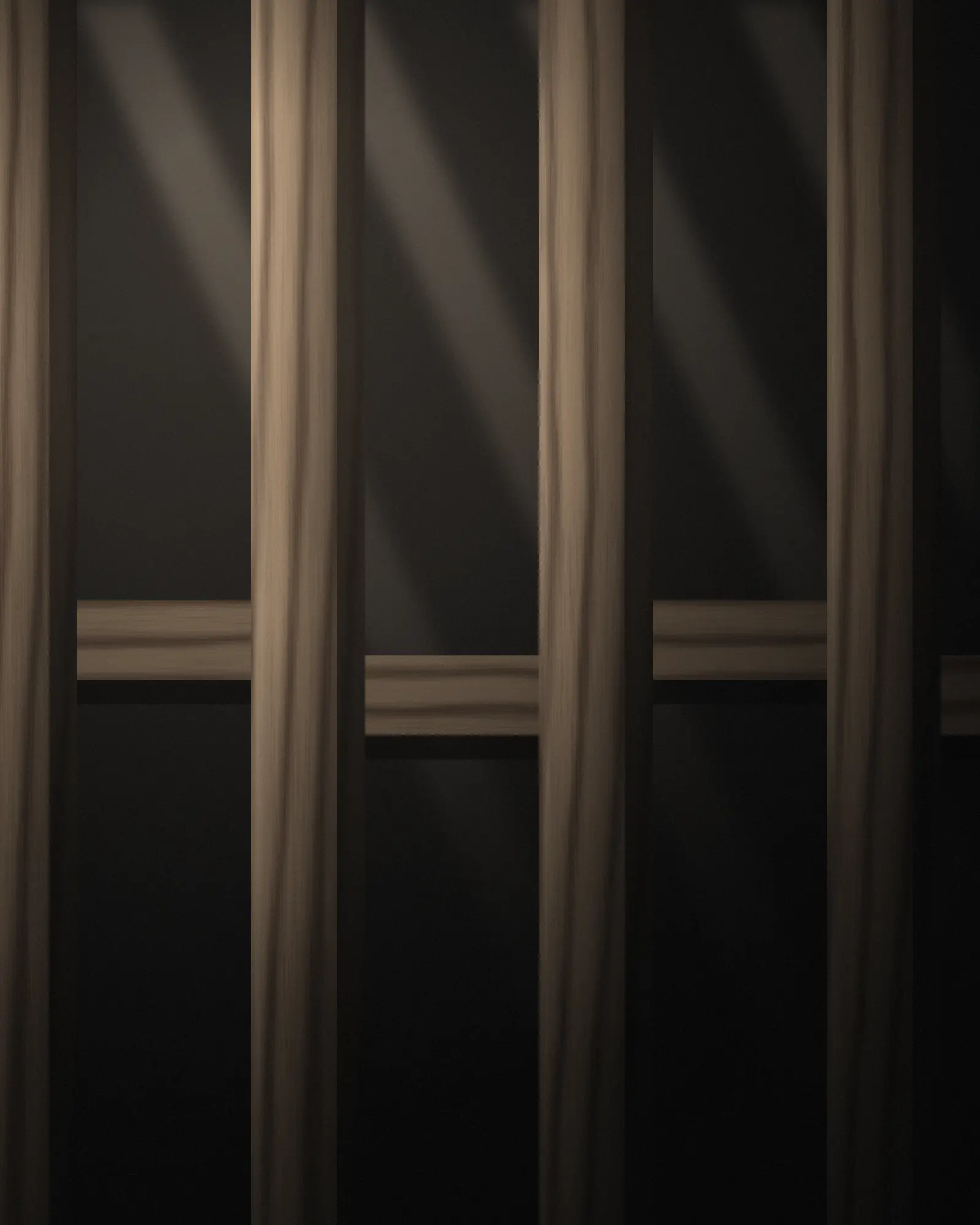 Timber wall frame with light falling across the studs